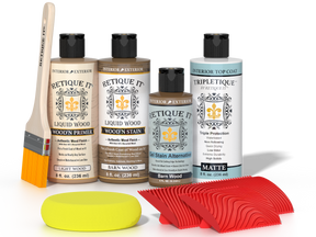 Retique It® Barn Wood Wood'n Kit with Light Wood primer, Barn Wood stain, Barn Wood gel stain alternative, Matte Tripletique® Top Coat, brush, red graining tool, and yellow sponge.