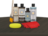 Retique It® Wood'n Finish Kit in Charcoal for tabletops, featuring stain bottles and applicators on a wooden surface.