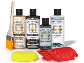 Retique It® Charcoal Wood'n Kit with Light Wood primer, Charcoal stain, Charcoal gel stain alternative, Matte Tripletique® Top Coat, brush, red graining tool, and yellow sponge.