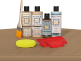 Retique It® Wood'n Finish Kit in Pickled Oak stain displayed on table, showcasing natural wood finish for furniture projects.