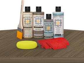Retique It® Wood'n Finish Kit in Weathered Wood stain, showing a tabletop with weathered wood finish and stain application.