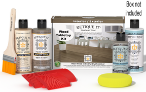 Retique It® Wood'n Finish Kit in Weathered Wood stain, featuring a box with stain bottles and application tools on a wooden surface.