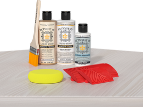 Retique It® Fireplace Mantel Wood'n Finish Kit in White Wash stain displayed on a table, showing natural wood grain and finish details.