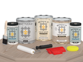 Sun-bleached Retique It Wood'n Finish Kit with four large exterior top coat containers on a table, matte finish for wood projects.