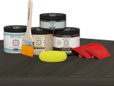 Retique It® Wood'n Finish Kit in Charcoal for tabletops, showing the double-sized stain set with wood grain and stain application.