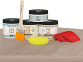 Sun-bleached Mid-sized Wood'n Finish Kit by Retique It® for interior top coating, featuring wood finish tools on a table.