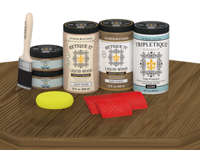 Retique It Wood'n Finish Kit with four large barn wood stain bottles on a tabletop, showcasing glossy wood stain application.