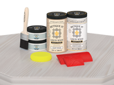 Retique It® Wood'n Cabinet Kit with 12 white wash grained door stains, displayed on a table showing wood grain detail.